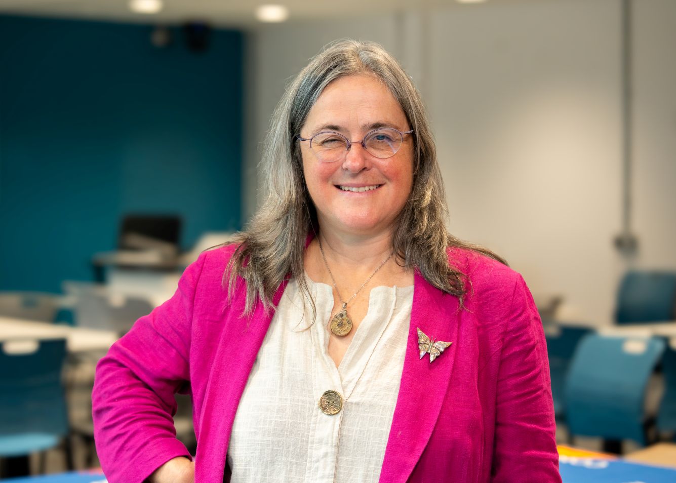 Picture of Joanne Tippett. A female academic at the University of Manchester wearing a white shirt and a pink blazer over the top.